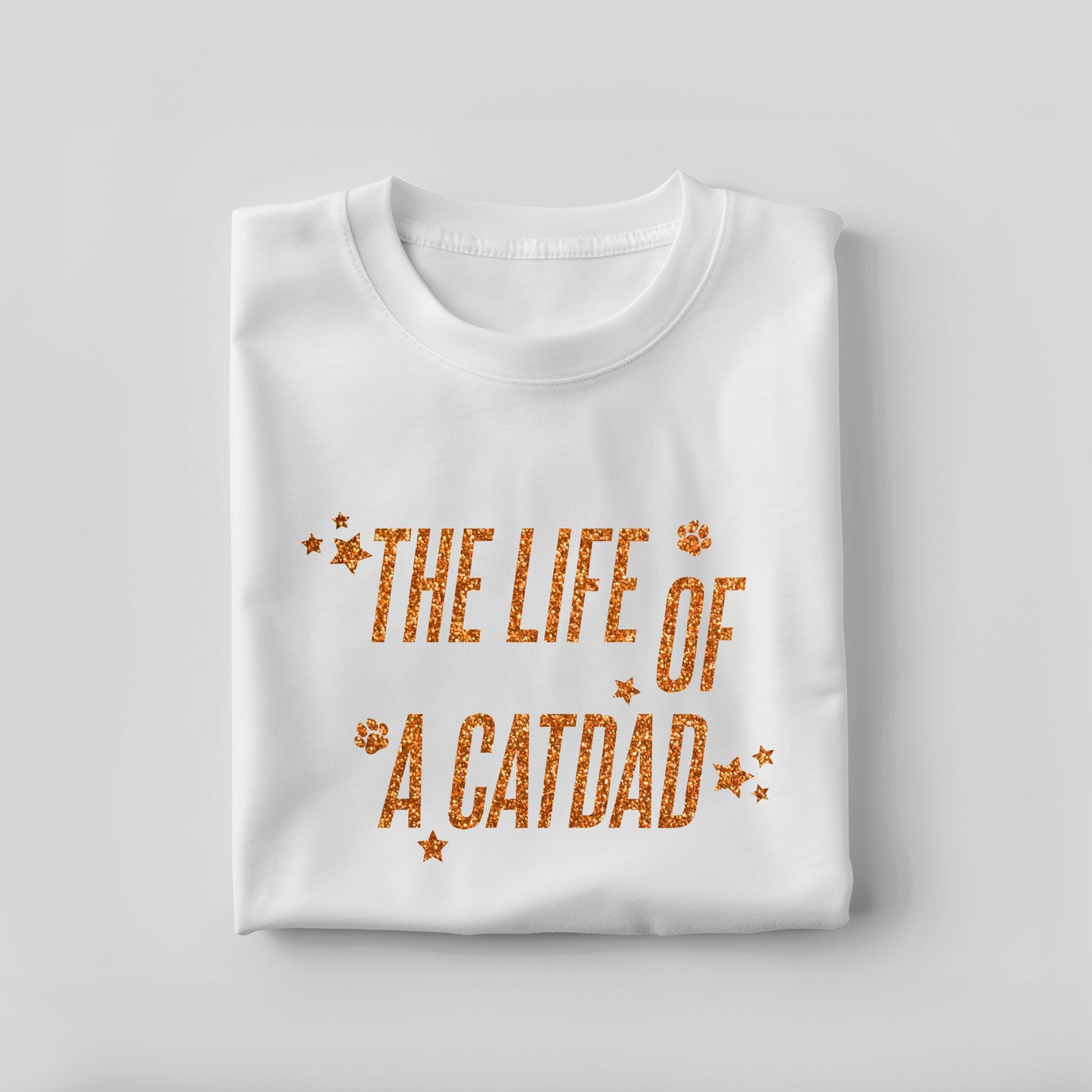 White t-shirt with 'The Life of a Cat Dad' text on a light gray background
